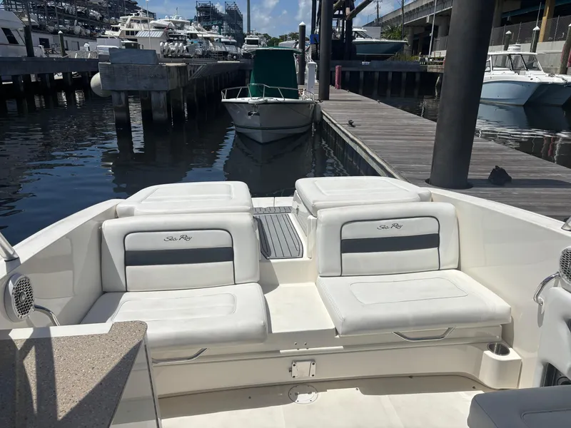 Slide: The Image of 2014 Sea Ray 300 SLX boat interior with white seating at a marina dock. - 5