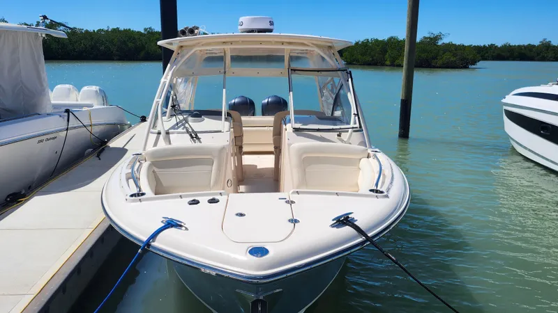 Slide: The Image of 2020 Grady-White Freedom 285 boat docked in a serene marina setting. - 1