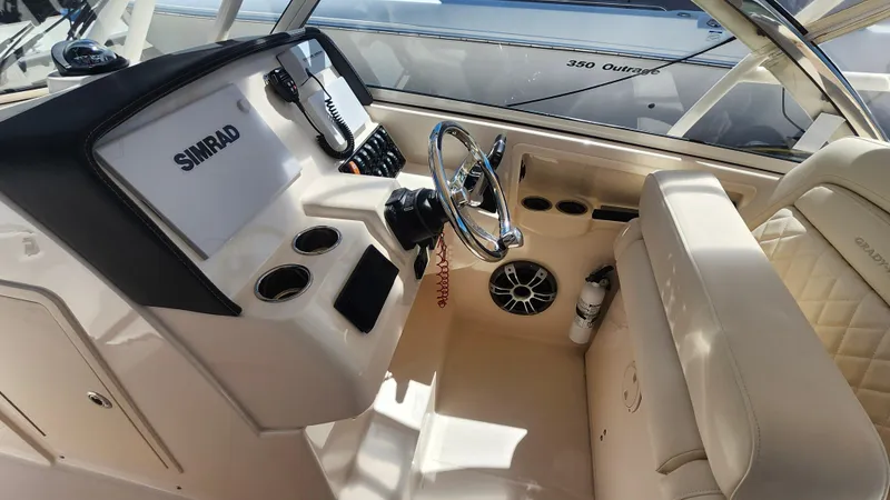 Slide: The Image of Interior of a 2020 Grady-White Freedom 285 boat with steering wheel and Simrad electronics. - 7