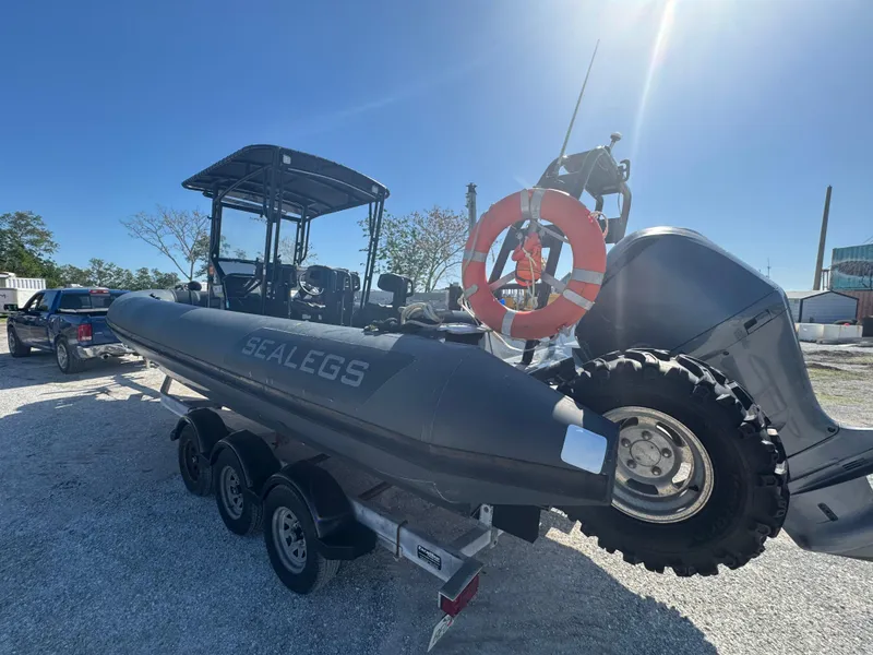 Slide: The Image of 2020 Sea Legs Hydrasol Amphibious RIB 30 on trailer, featuring rugged wheels and lifebuoy. - 11