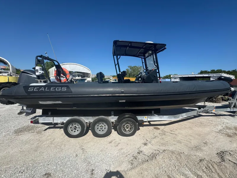 Slide: The Image of 2020 Sea Legs Hydrasol Amphibious RIB 30 on trailer, parked outdoors under clear blue sky. - 19