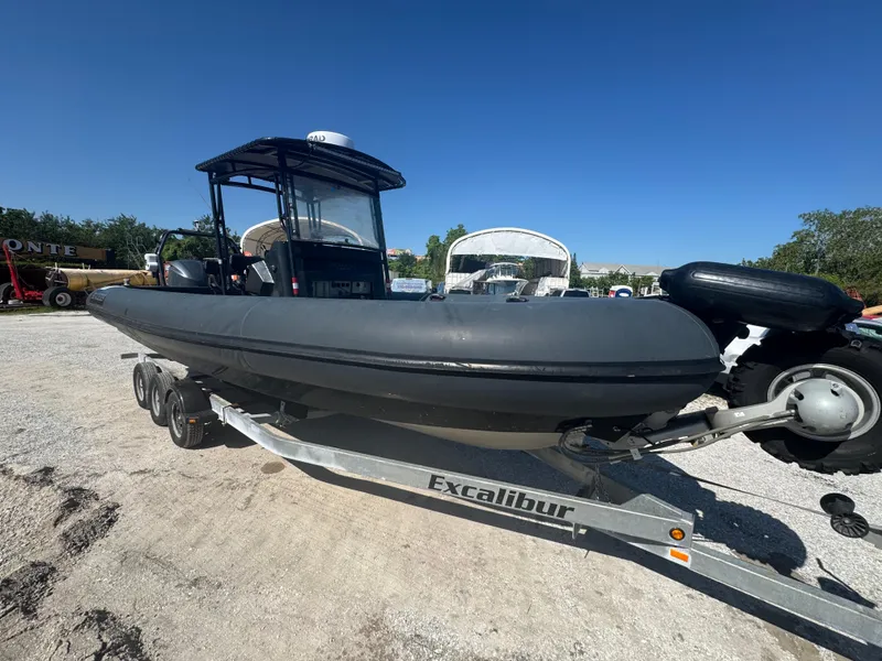 Slide: The Image of 2020 Custom Sea Legs Hydrasol Amphibious RIB 30 on Excalibur trailer, parked outdoors. - 21