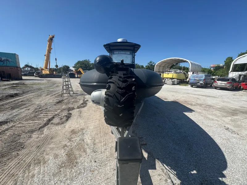 Slide: The Image of Amphibious RIB 30 with large wheels on gravel, surrounded by vehicles and equipment. - 22