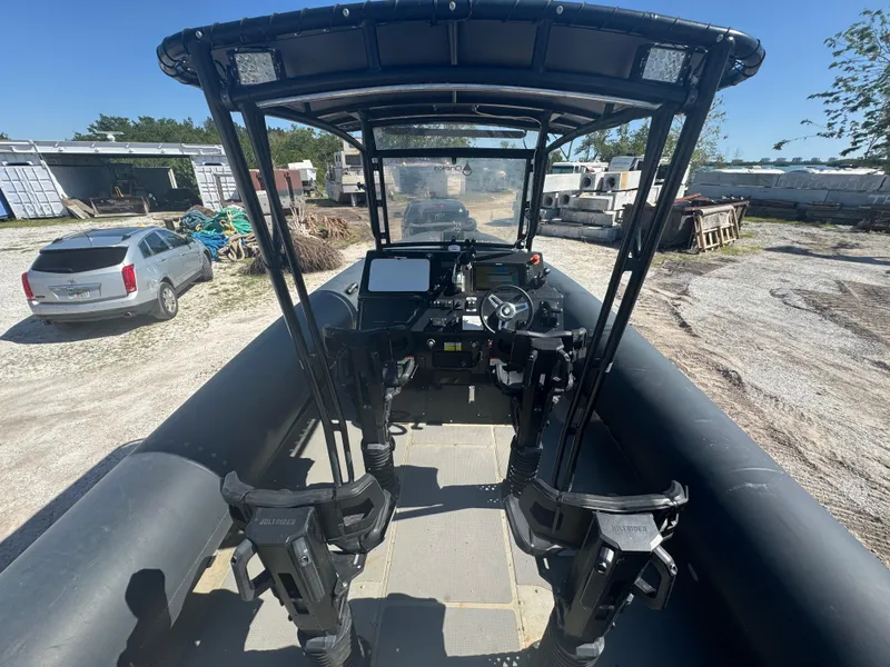 Slide: The Image of Amphibious RIB boat with advanced controls, parked on land, featuring a sturdy black frame. - 24