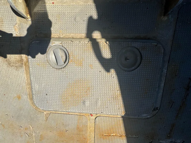 Slide: The Image of Amphibious RIB 30 deck with hatch covers, shadow cast on textured surface. - 35