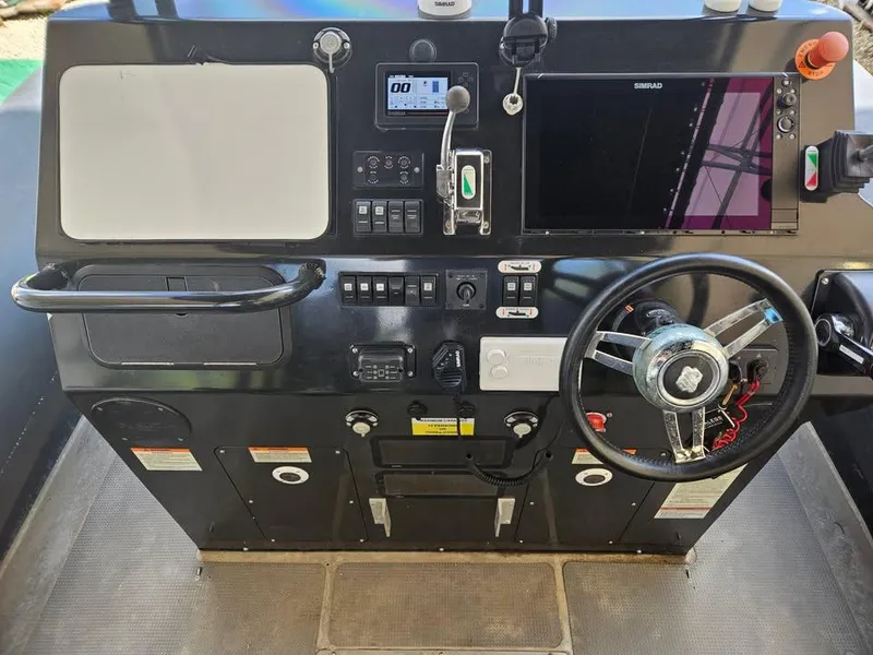 Slide: The Image of Control panel of 2020 Sea Legs Hydrasol Amphibious RIB 30 with steering wheel and navigation equipment. - 4