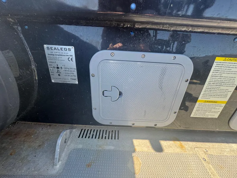 Slide: The Image of Close-up of 2020 Sea Legs Hydrasol Amphibious RIB 30 panel with labels and warnings. - 42