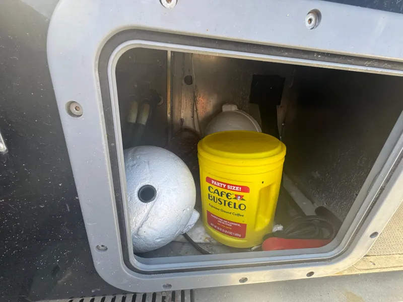 Slide: The Image of Storage compartment of a 2020 Sea Legs Hydrasol Amphibious RIB 30 with Café Bustelo can. - 43