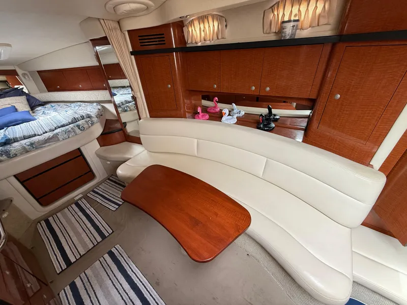 Slide: The Image of Interior of 2005 Sea Ray 340 Sundancer with white seating and wooden accents. - 18