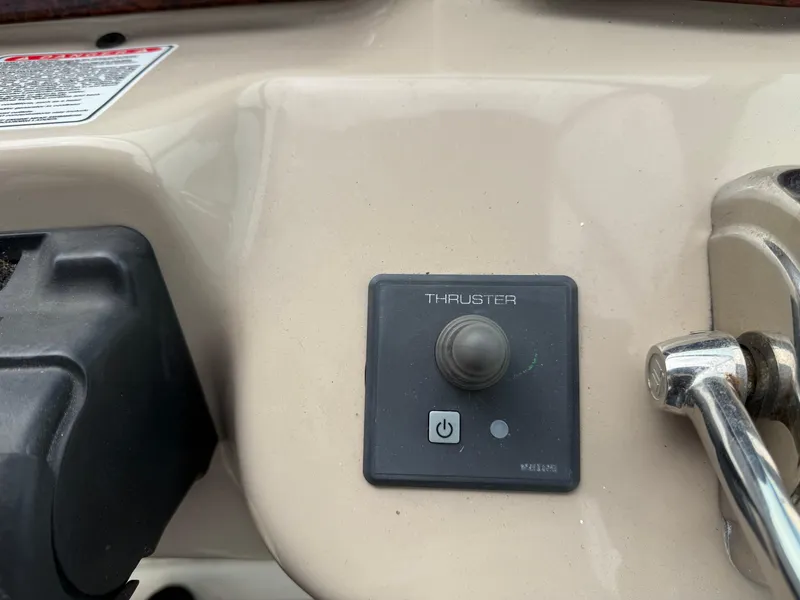 Slide: The Image of Control panel of a 2005 Sea Ray 340 Sundancer boat, featuring a thruster button. - 20