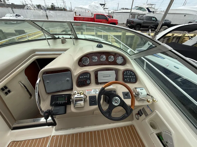 Slide: The Image of 2005 Sea Ray 340 Sundancer helm with gauges, steering wheel, and navigation controls. - 21