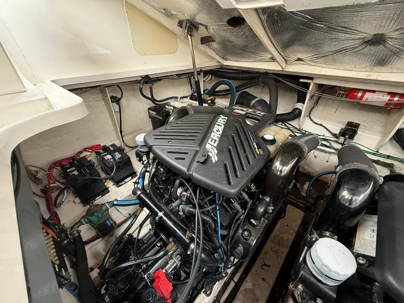 Slide: The Image of Engine compartment of a 2005 Sea Ray 340 Sundancer boat, featuring a MerCruiser engine. - 24