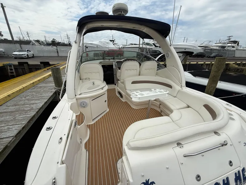 Slide: The Image of 2005 Sea Ray 340 Sundancer boat with spacious seating and elegant interior at a marina. - 35