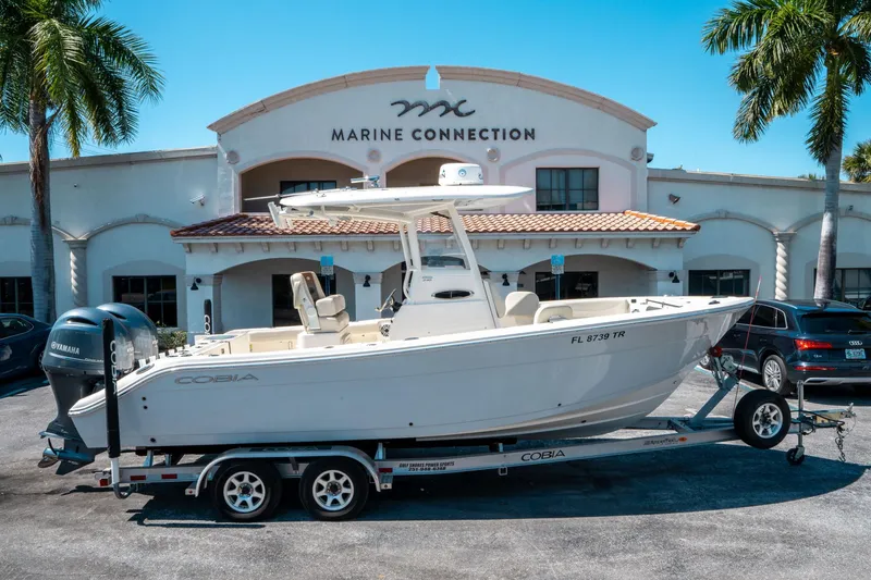 Slide: The Image of 2023 Cobia 240 CC boat on trailer at Marine Connection dealership. - 1