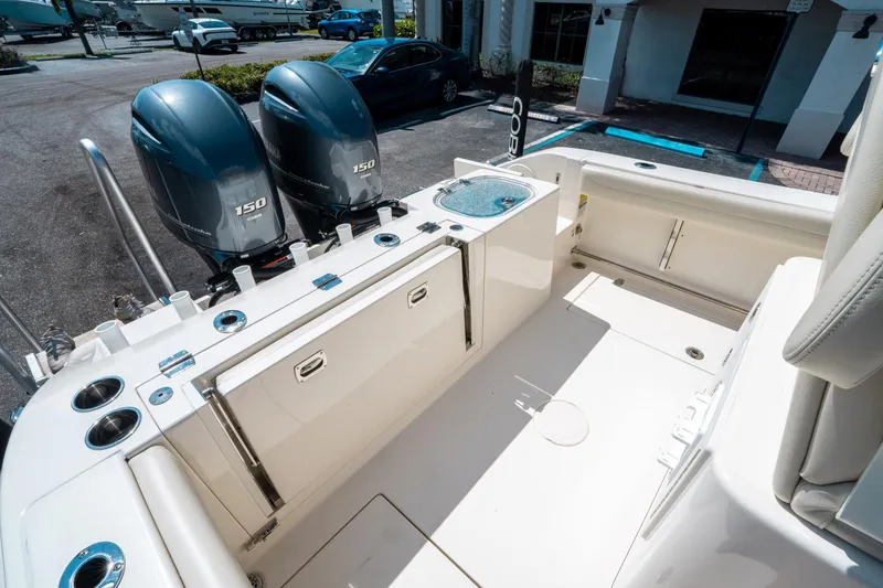 Slide: The Image of 2023 Cobia 240 CC boat with dual Yamaha 150 engines, spacious deck layout. - 11