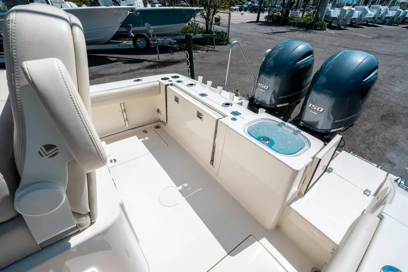 Slide: The Image of 2023 Cobia 240 CC boat interior with dual 150 horsepower engines. - 12