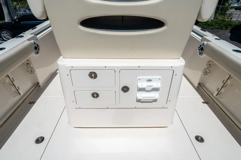 Slide: The Image of 2023 Cobia 240 CC boat interior with storage compartments and seating. - 14