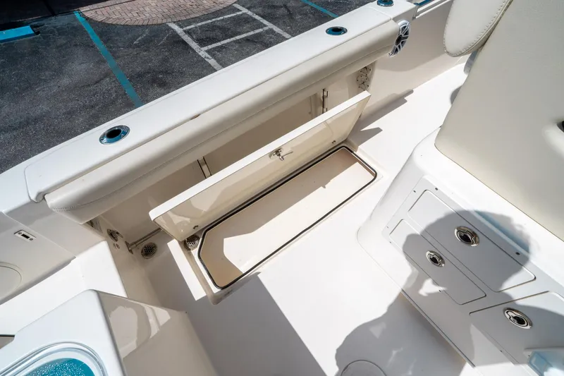 Slide: The Image of 2023 Cobia 240 CC boat interior with open storage compartment. - 16