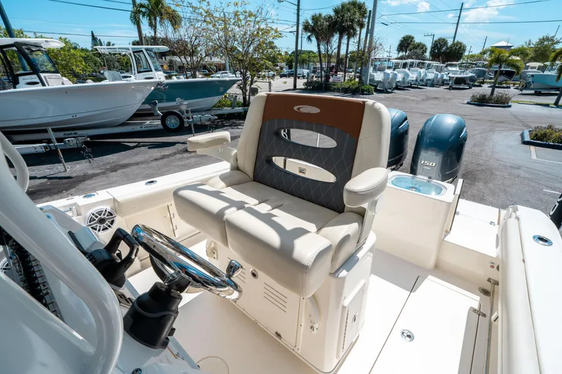 Slide: The Image of 2023 Cobia 240 CC boat interior with dual engines and comfortable seating. - 24