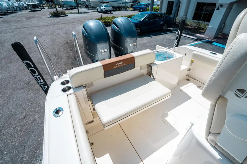 Slide: The Image of 2023 Cobia 240 CC boat interior with dual engines and seating area. - 25