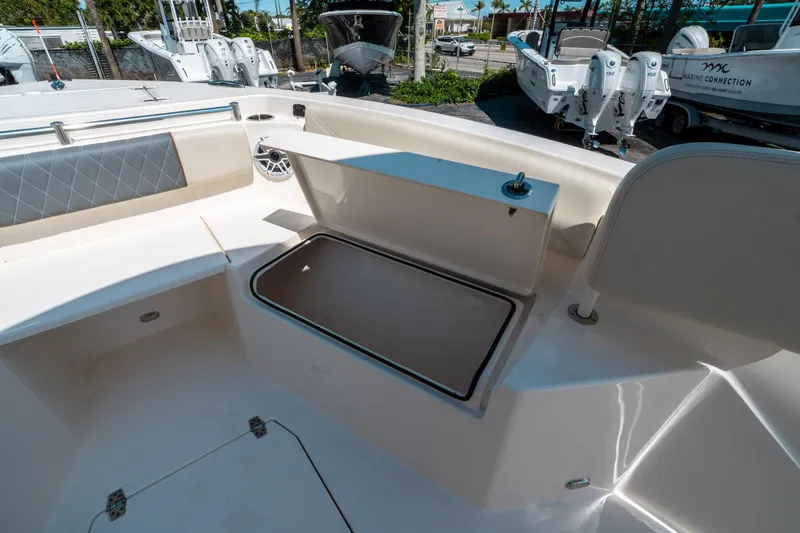 Slide: The Image of 2023 Cobia 240 CC boat interior with storage compartment and seating. - 33