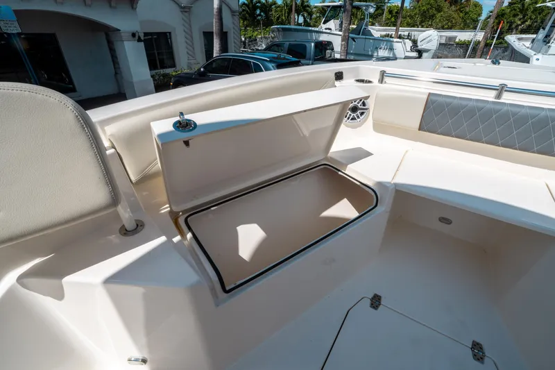 Slide: The Image of 2023 Cobia 240 CC boat interior with open storage compartment. - 34