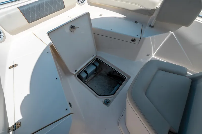 Slide: The Image of 2023 Cobia 240 CC boat interior with open storage compartment. - 35