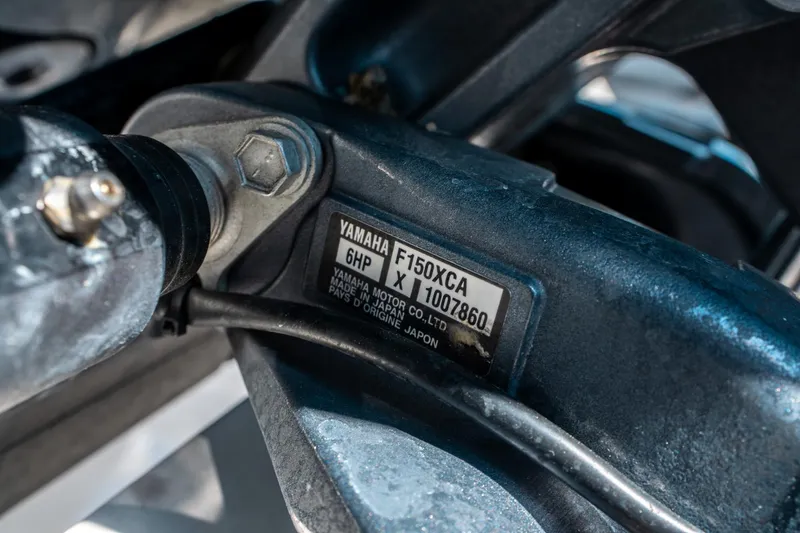 Slide: The Image of Close-up of Yamaha F150XCA engine part on 2023 Cobia 240 CC boat. - 39