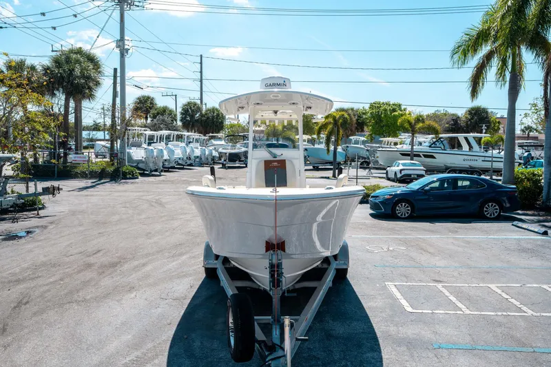 Slide: The Image of 2023 Cobia 240 CC boat on trailer in sunny parking lot. - 7