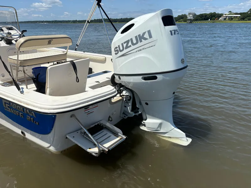 Slide: The Image of 2021 Carolina Skiff 21 LS boat with Suzuki 175 outboard motor on calm water. - 6