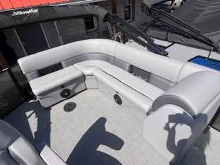 Slide: The Image of 2025 Bentley Pontoons 220 Cruise XL interior with gray seating and carpeted flooring. - 3