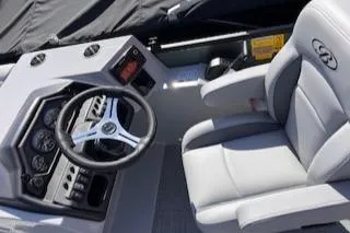 Slide: The Image of 2025 Bentley Pontoons 220 Cruise XL interior with steering wheel and captain's chair. - 5