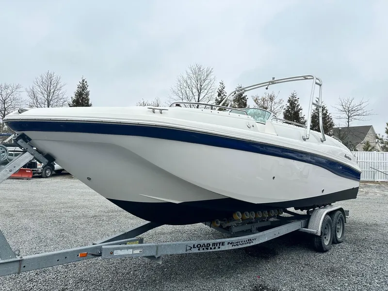 Slide: The Image of 2004 Godfrey Hurricane 260 Sun Deck boat on trailer, parked outdoors. - 0