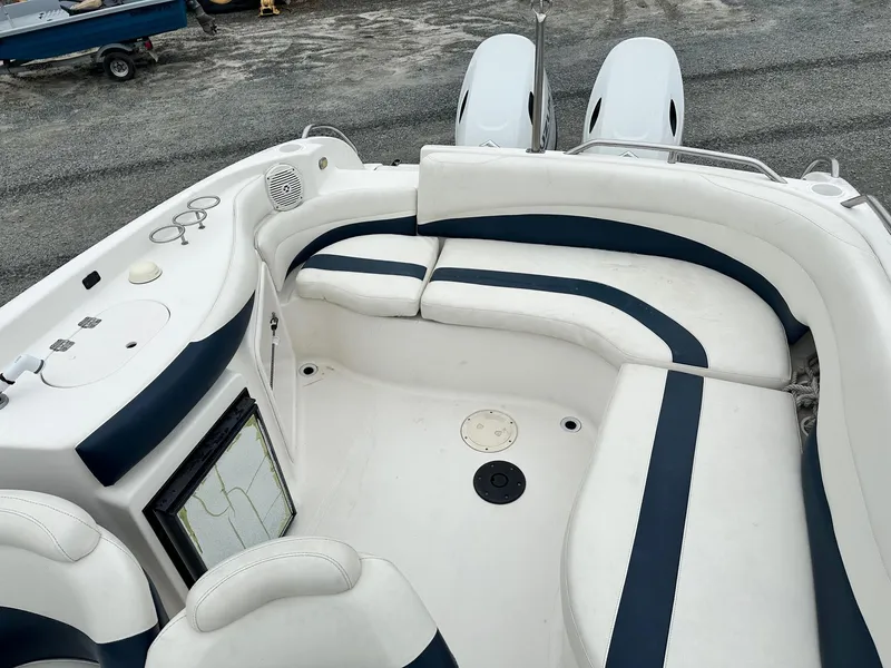 Slide: The Image of 2004 Godfrey Hurricane 260 Sun Deck boat interior with white and blue seating. - 10