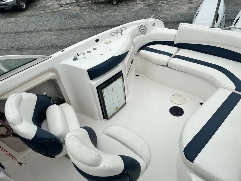 Slide: The Image of 2004 Godfrey Hurricane 260 Sun Deck interior with white and navy seating. - 12