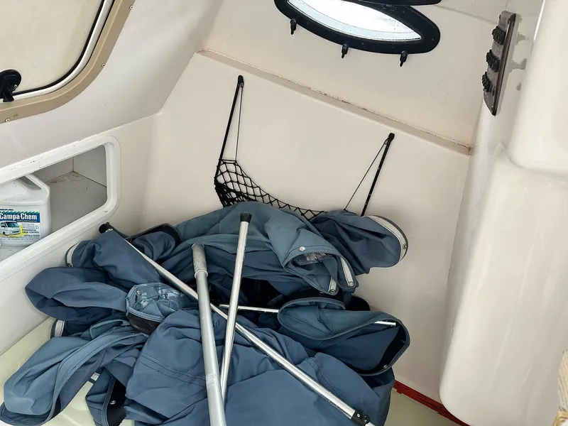 Slide: The Image of Interior of 2004 Godfrey Hurricane 260 Sun Deck with storage and equipment. - 14