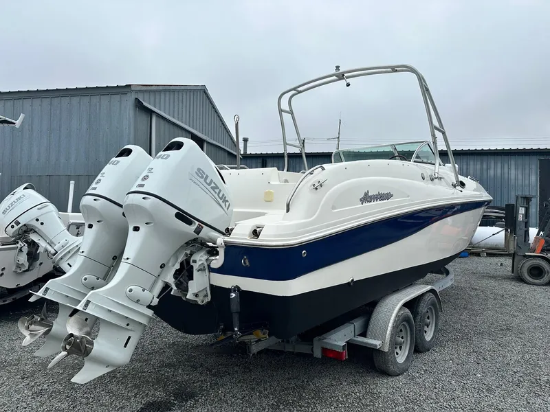 Slide: The Image of 2004 Godfrey Hurricane 260 Sun Deck boat on trailer with dual Suzuki outboard engines. - 3