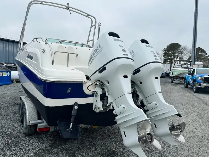 Slide: The Image of 2004 Godfrey Hurricane 260 Sun Deck boat with dual Suzuki outboard motors on a trailer. - 4