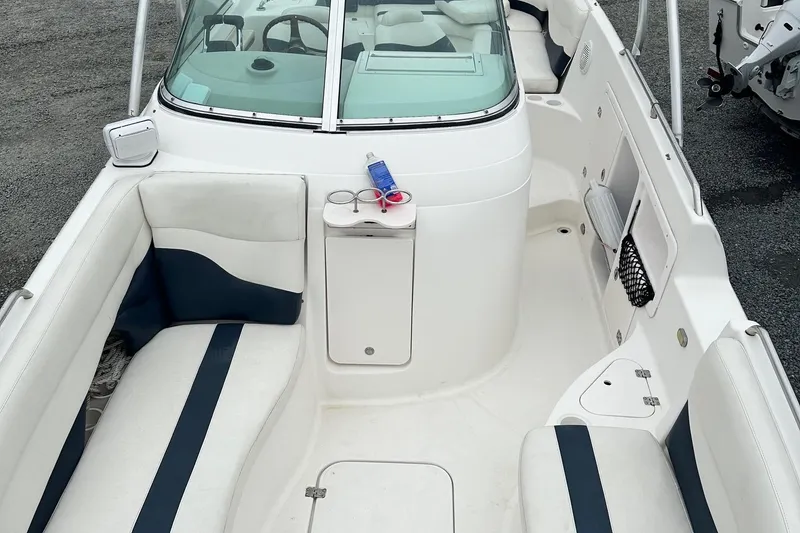 Slide: The Image of 2004 Godfrey Hurricane 260 Sun Deck boat interior with white and navy seating. - 7