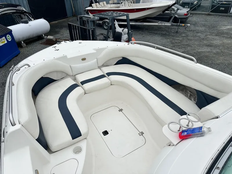 Slide: The Image of 2004 Godfrey Hurricane 260 Sun Deck boat interior with white and navy seating. - 9