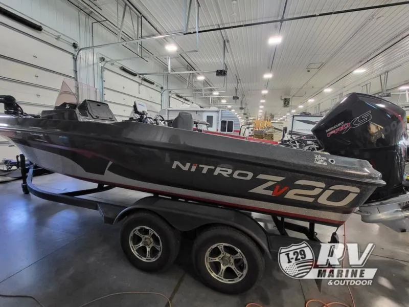 Slide: The Image of 2022 Nitro ZV20 boat in indoor showroom, displayed on a trailer. - 3