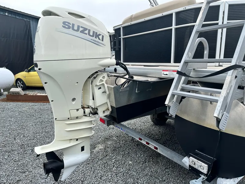 Slide: The Image of 2019 Godfrey Sweetwater 2086C with Suzuki outboard motor on trailer. - 11