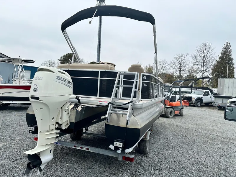 Slide: The Image of 2019 Godfrey Sweetwater 2086C pontoon boat with Suzuki outboard motor on trailer. - 2