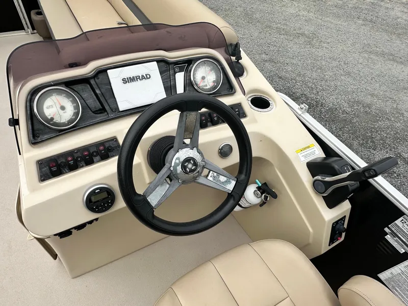 Slide: The Image of 2019 Godfrey Sweetwater 2086C boat dashboard with steering wheel and Simrad display. - 3