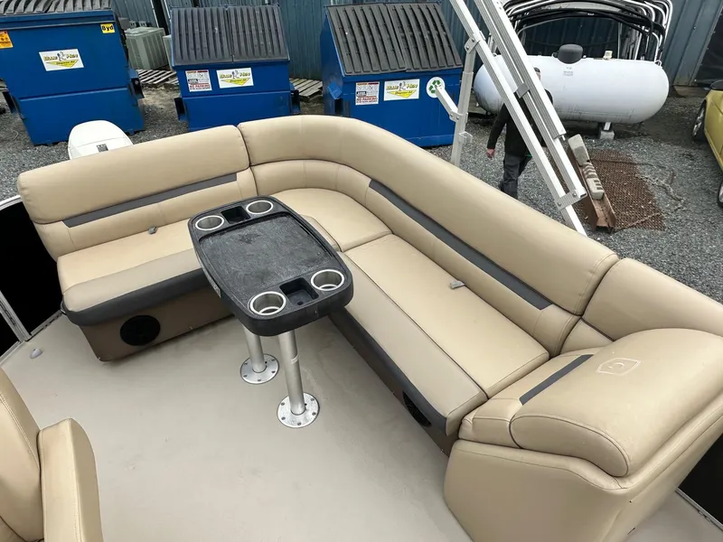 Slide: The Image of 2019 Godfrey Sweetwater 2086C pontoon boat with beige seating and a central table. - 7