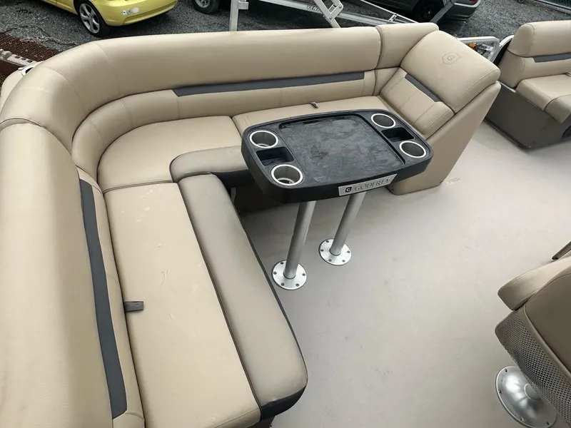 Slide: The Image of 2019 Godfrey Sweetwater 2086C pontoon boat interior with beige seating and table. - 8