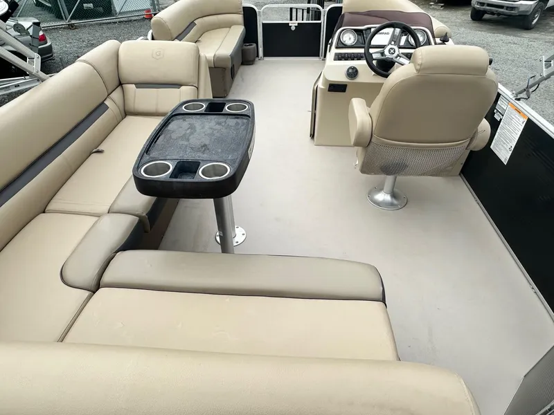 Slide: The Image of 2019 Godfrey Sweetwater 2086C pontoon boat interior with beige seating and steering console. - 9