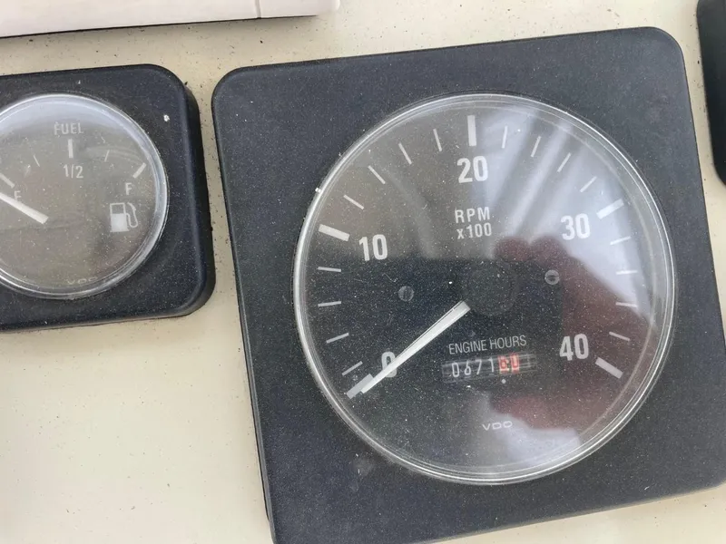 Slide: The Image of Close-up of 2003 Carolina Classic 28 boat gauges showing RPM and fuel levels. - 10