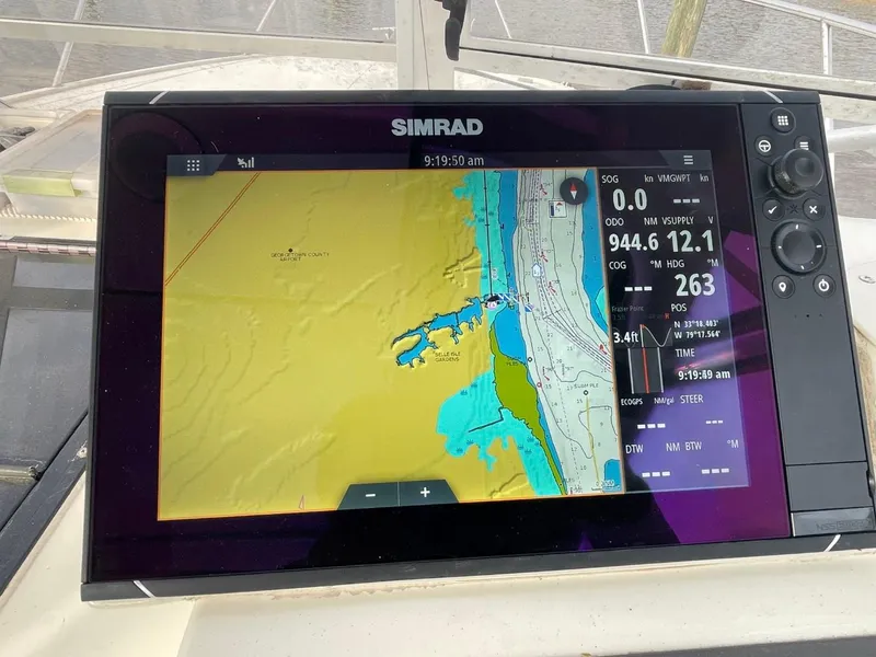 Slide: The Image of Simrad navigation display on a 2003 Carolina Classic 28 boat, showing nautical charts and data. - 15