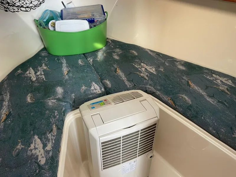 Slide: The Image of Interior of 2003 Carolina Classic 28 boat with air conditioner and storage bin. - 16